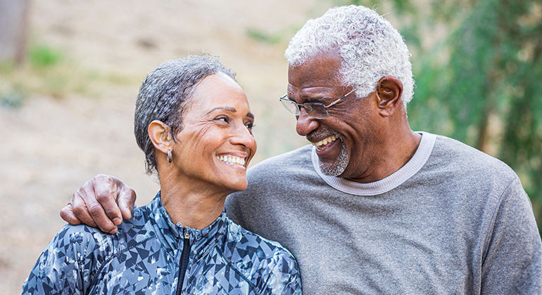 senior couple smiling at one another